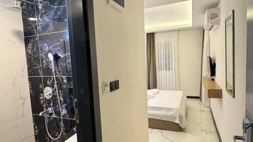 Deluxe Double Room, Balcony | Bathroom | Shower, hair dryer, towels, soap