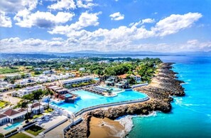 A resort with multiple swimming pools, a beach, and a rocky coastline. - Sosua Ocean Village Luxury Villa: 3BR/3.5BA Pool Oasis (Sosúa)