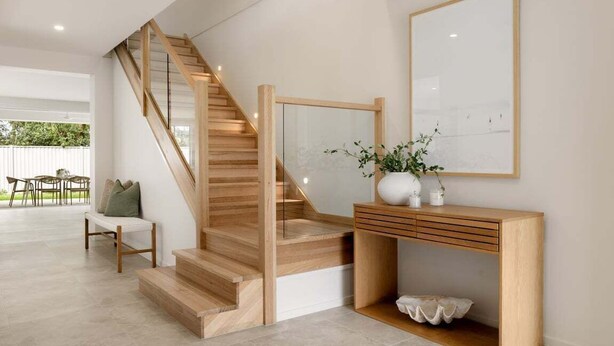 A staircase with wooden steps and a glass railing, leading to an upper floor. - Mooloolaba Family 5 Bedroom Haven (Sunshine Coast)