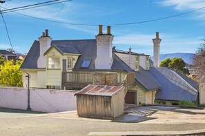 A two-story house with a balcony, a wooden shed, and a metal roof. - Hill Street Hideaway (West Hobart)