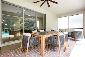 Whether you're sipping your morning coffee, grilling up a family feast, or sharing a sunset meal by the pool, this inviting space creates the perfect setting for unforgettable moments together. - Designer 8BR Villa | Private Pool, Spa & Lanai (Kissimmee)