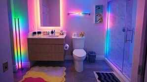 A bathroom with a toilet, sink, and shower area.