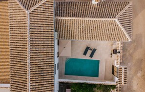 An aerial view of a property with a swimming pool, outdoor seating, and a tiled roof. - Gorgeous home in Iznajar (Iznajar)