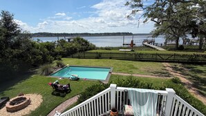 A backyard with a swimming pool, a deck, and a view of a lake. - DEEP WATER DOCK, PRIVATE POOL (Midway)