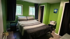 A bedroom with a bed, a desk, a chair, and a window. - 2 bedroom home in Fort Frances Ontario (Fort Frances)