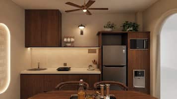 A modern kitchen with a central island, built-in appliances, and a ceiling fan.