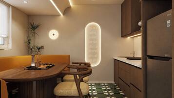 A modern kitchen with a built-in LG refrigerator, wooden cabinets, and a dining area with a wooden table and chairs.