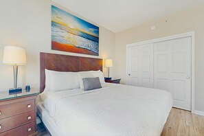 A hotel room with a large bed, two bedside lamps, a painting above the bed, and a white door. - 2407 New Listing Special ~ Book Sept 7th ~ Pools ~ Gym ~ Onsite Restaurant & Bar (Destin)