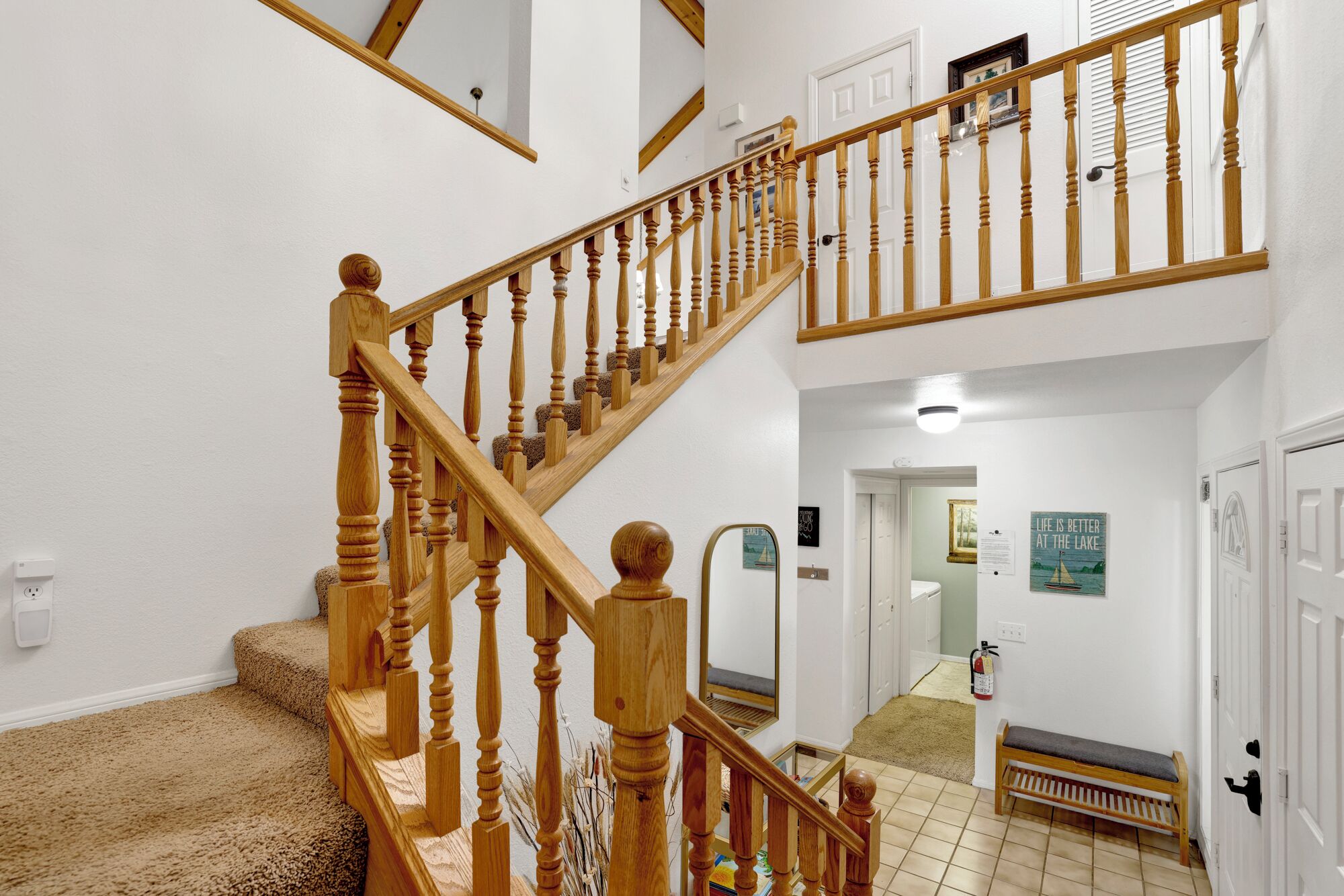 A wooden staircase with a handrail leading to an upper floor.