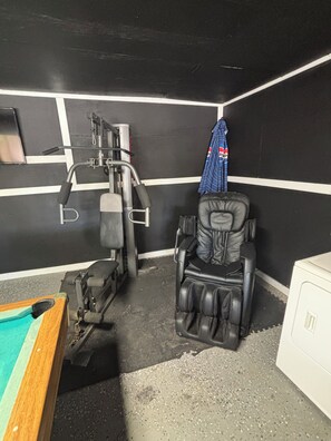 A room with a massage chair, a pool table, and a wall-mounted exercise machine. -    Private pool, Three bedroom, Family-Friendly Home with Game Room & Fast Wi-Fi (Corpus Christi)
