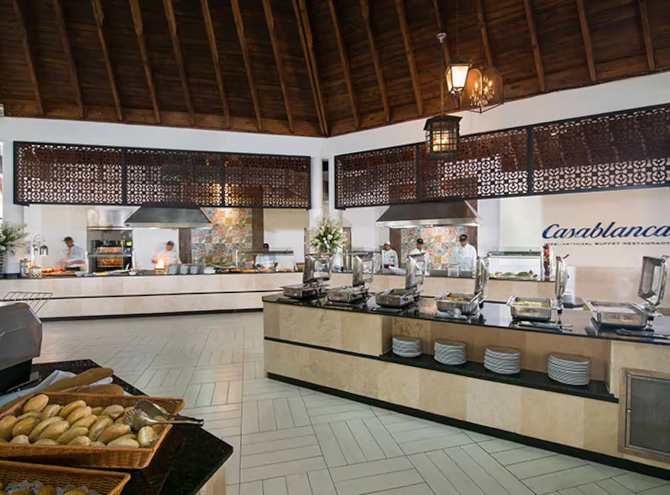 A spacious buffet area with a high ceiling and decorative wooden beams.