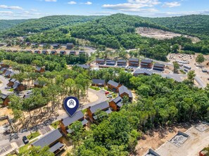 A residential area with multiple two-story houses, a parking lot, and a large open space with construction. - Cozy Tall Timbers Retreat_Pvt Hot Tub_Near Lazy River_Free Tickets_Shuffleboard_Arcade (Hollister)