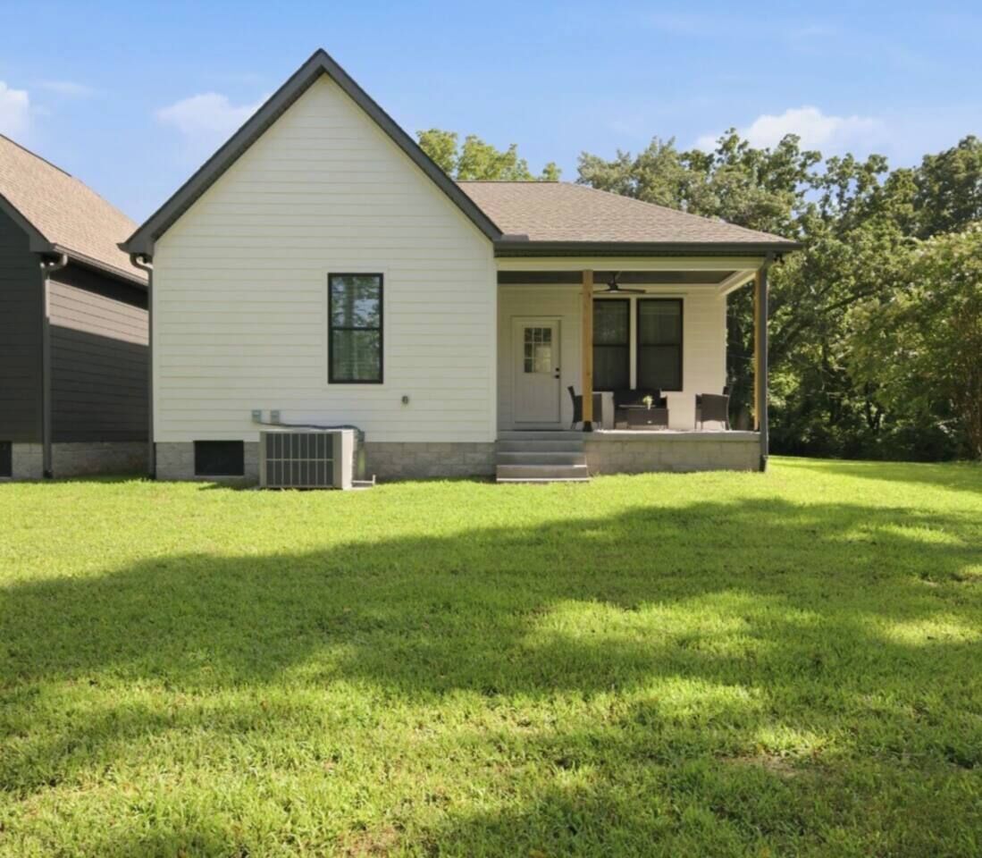 A single-story house with a front porch, a small attached garage, and a well-maintained lawn.