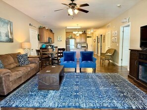 A living room with a sofa, two armchairs, a coffee table, and a patterned rug. - Lakefront 3BR condo at Table Rock Lake with pool, patio, and resort perks. (Hollister)