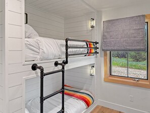 A bunk bed room with a window and two wall-mounted lanterns. - LEED Gold Retreat | Hot Tub | Near Tamarack (Donnelly)
