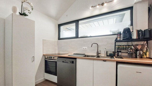 A modern kitchen with a dishwasher, oven, and a window above the sink. - 2 bedroom awesome home in Meschers-sur-Gironde (Meschers-sur-Gironde)