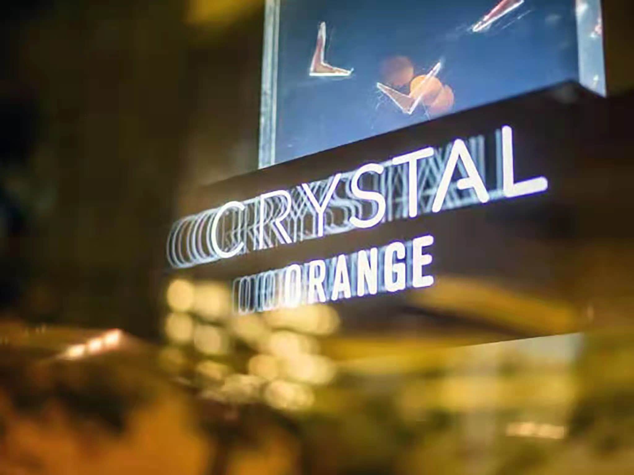 A sign with the text 'CRYSTAL ORANGE'.