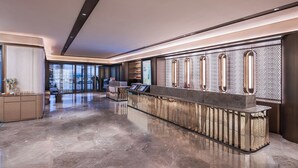 A modern hotel lobby with a reception desk, a seating area, and a view of the street through large windows. - Crystal Hotel Zhongguancun Renmin Univ. (Beijing)