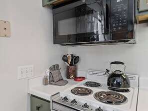 A kitchen with a microwave, stove, and various utensils. - Lodge at Mtn Village A223 | Ski-In/Out | PCMR Views | Pool & Hot Tubs (Park City)
