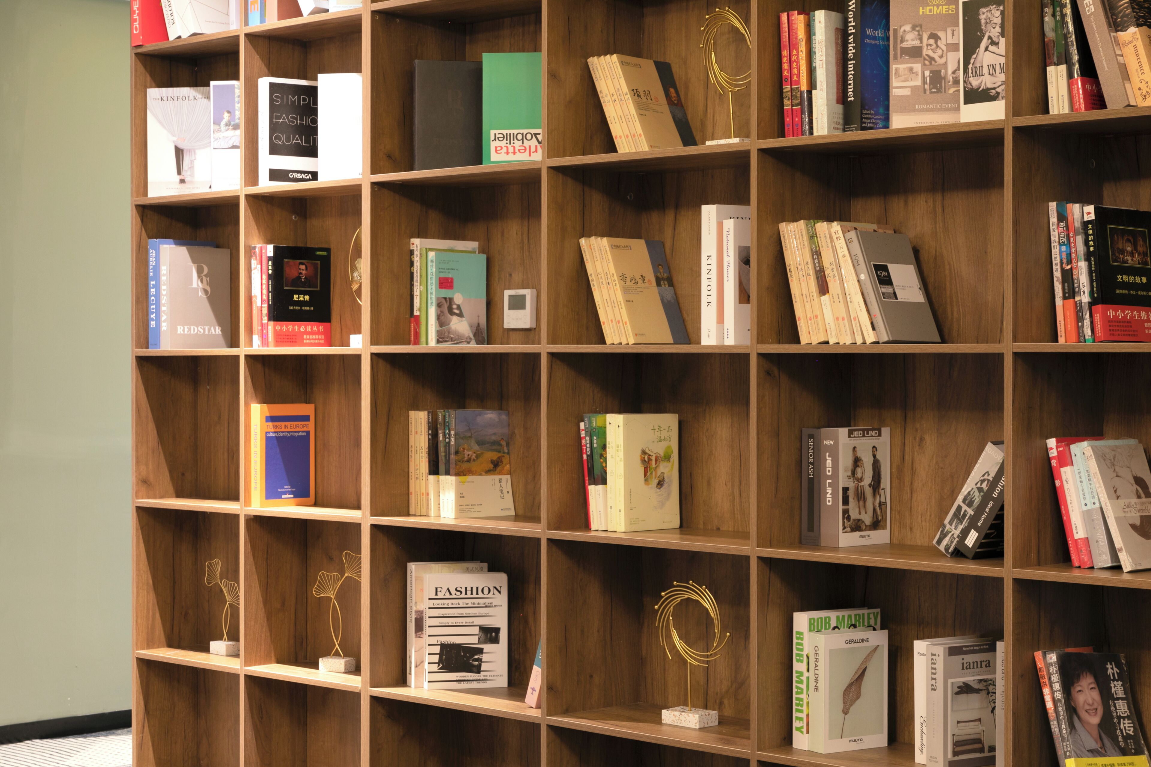 A bookshelf with various books and decorative items.
