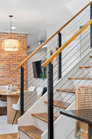 A staircase with wooden steps and metal railings. - Olive & Brick | Hot Tub • Private Backyard Oasis (Cincinnati)
