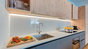 Coffee/tea maker, fridge, oven, stovetop - Residenza Larix 002 Modern Alpine Stay In San Bernardino | Ski, Hiking & Nature, San Bernardino, Switzerland (San Bernardino)