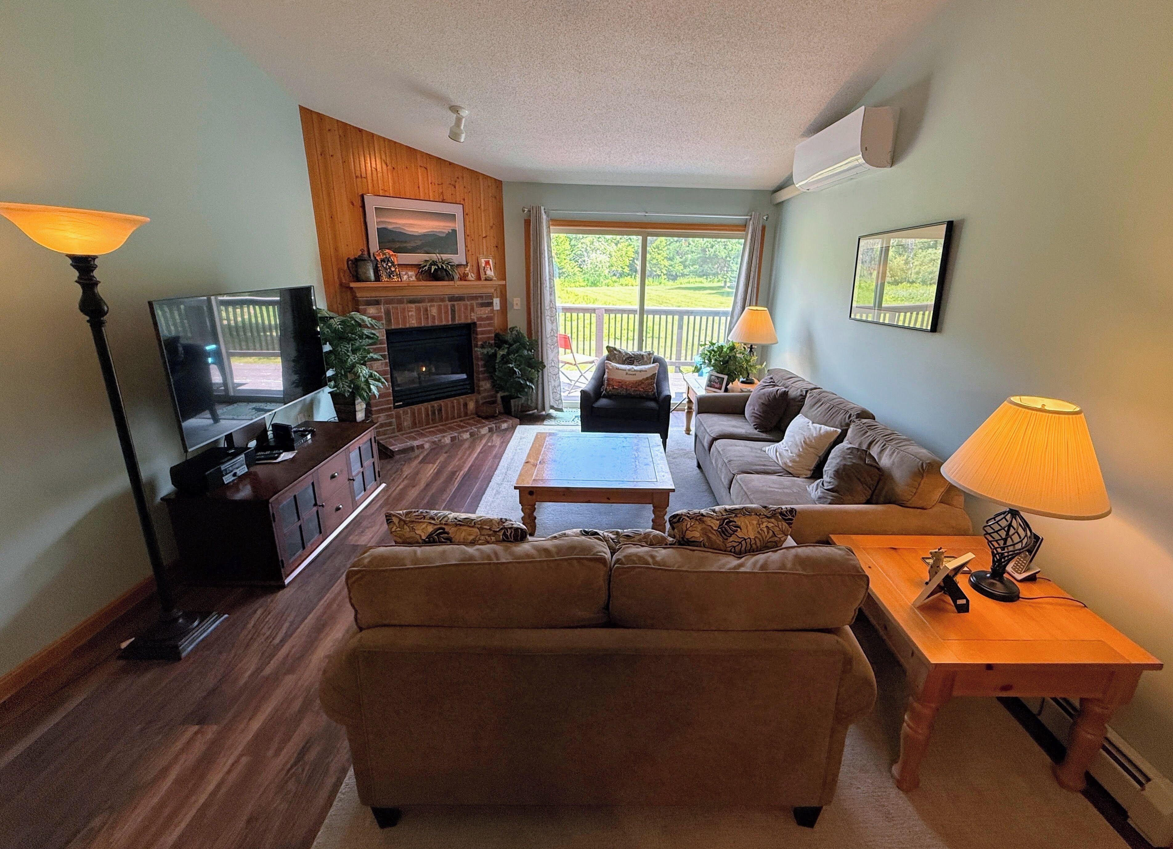 A living room with a fireplace, television, and seating area.