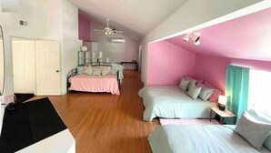 A bedroom with two beds, a wardrobe, a ceiling fan, and a window with curtains. - Luxury  Villa w/ Pool, Max Amenities (Kansas City)