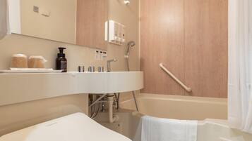 A modern bathroom with a white sink, a bathtub, and a shower.