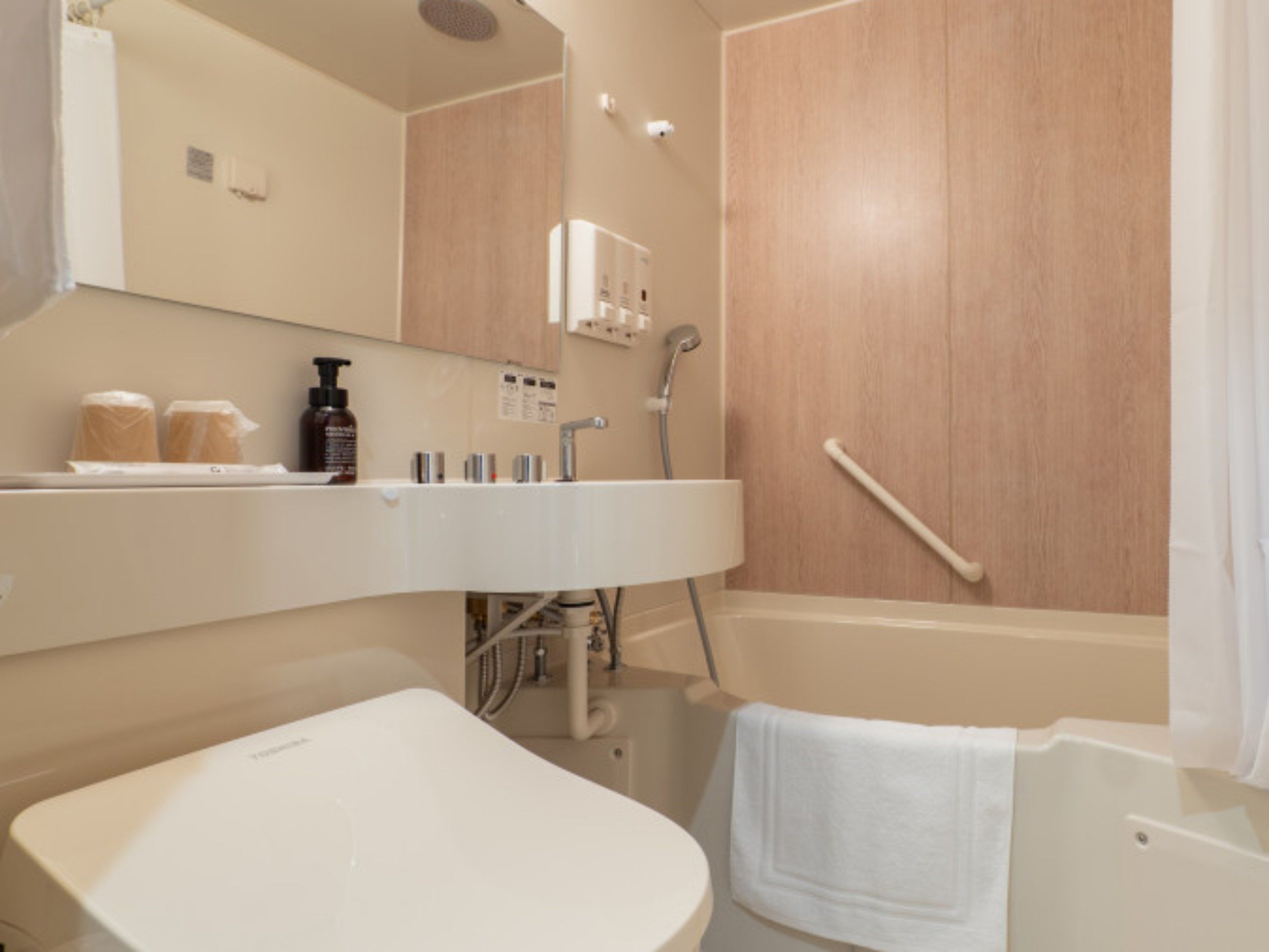 A modern bathroom with a bathtub, a sink, and a shower.