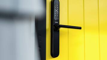 A door with a keypad lock and a keyhole.