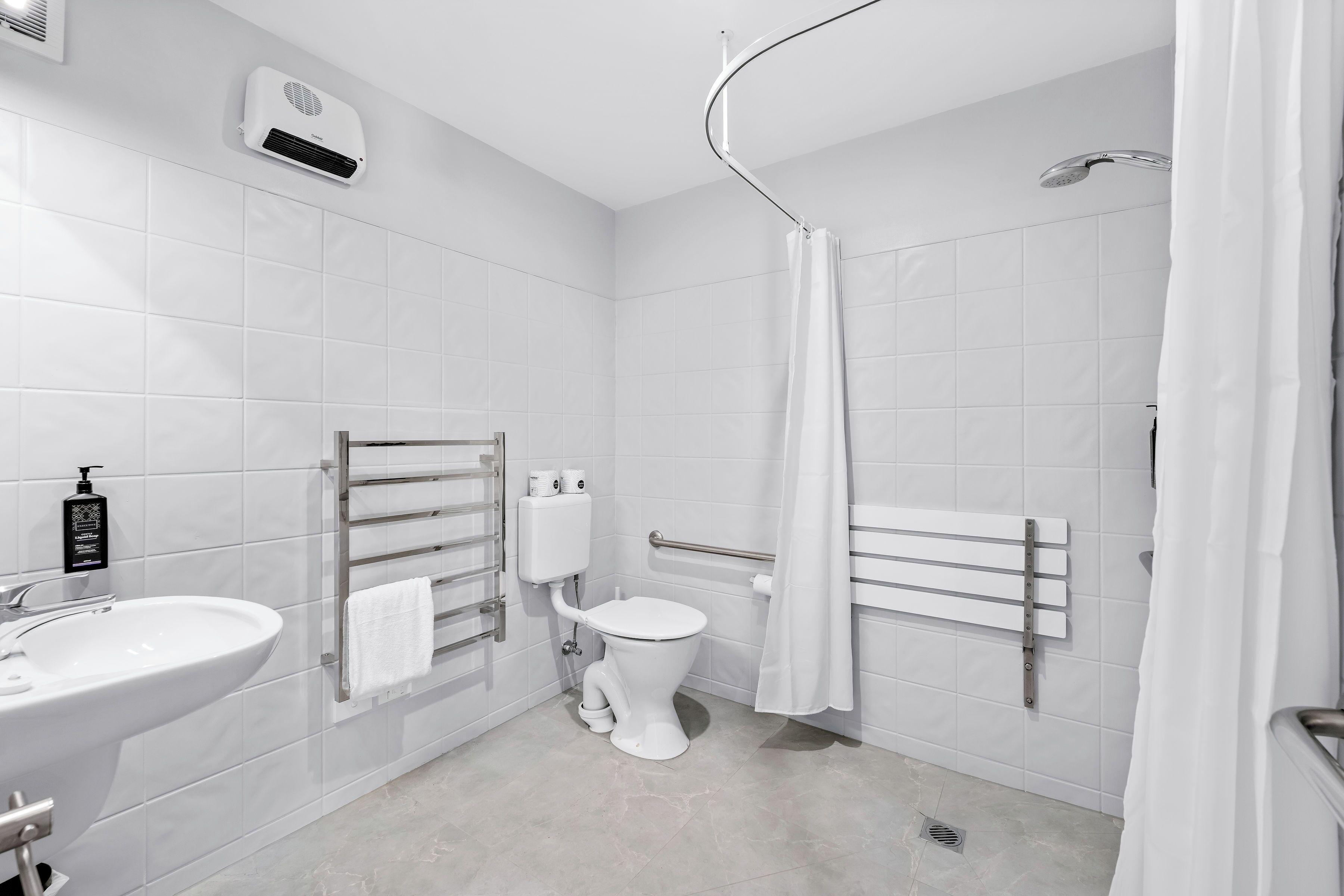 A modern bathroom with a toilet, bidet, and shower.