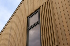 A building with a wooden facade and a large window.