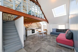 A spacious loft with a kitchen, dining area, and seating space.
