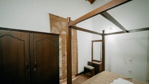 A bedroom with a bed, wooden wardrobe, and a mirror. - Skyport Villa Negombo (Negombo)