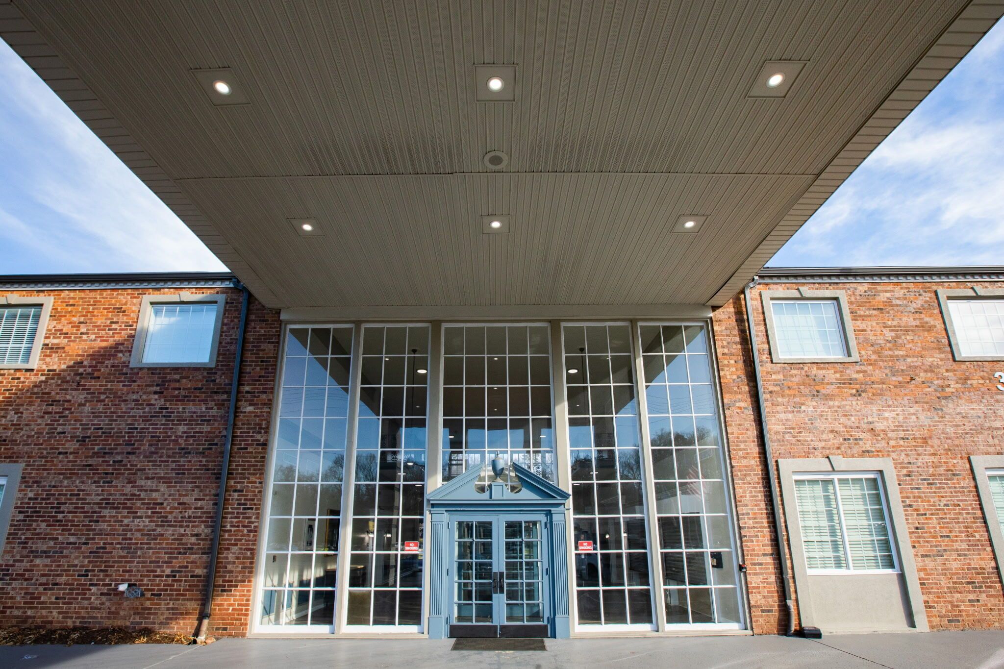 A building with large windows and a covered entrance.
