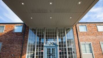 A building with large windows and a covered entrance.
