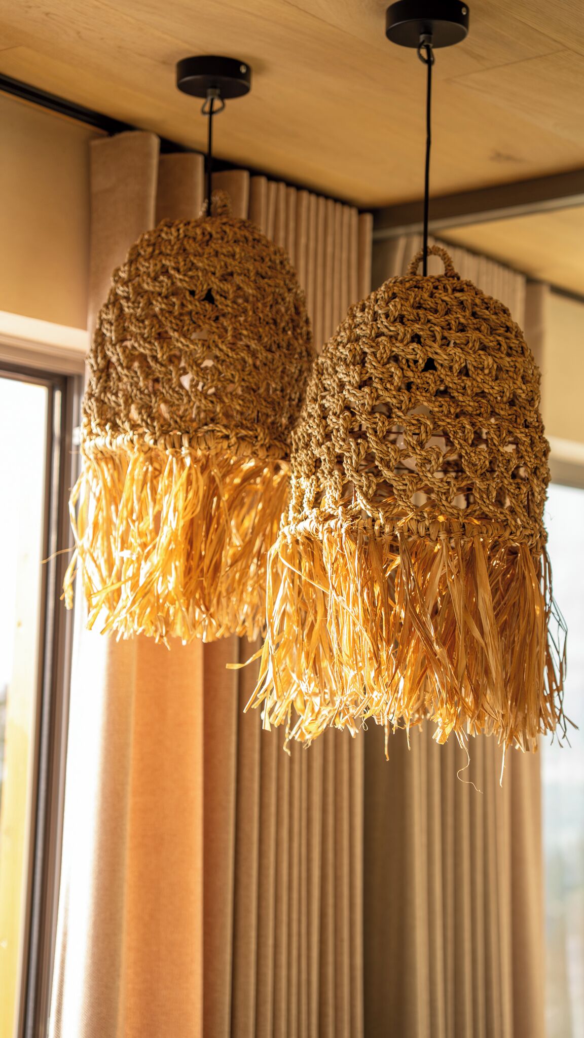 Two hanging light fixtures with a woven texture.