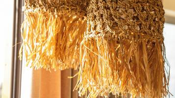 Two hanging light fixtures with a woven texture.