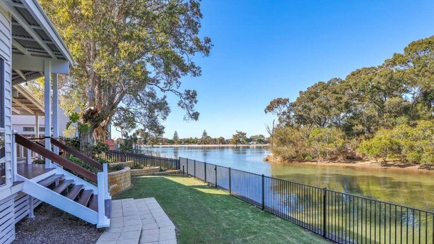 A property with a covered outdoor area, a staircase, and a view of a lake. - Luxury Waterfront Stay at Tallebudgera Creek (Gold Coast)