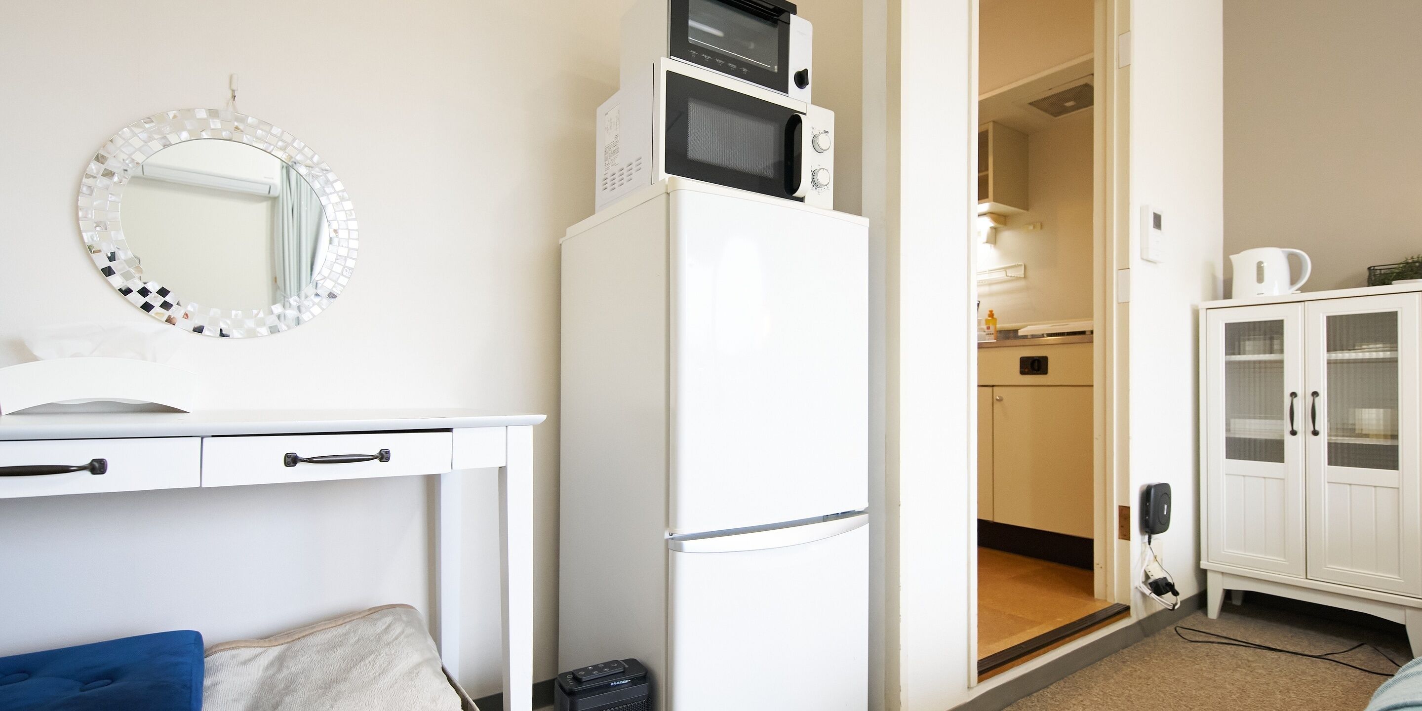 A compact kitchenette with a refrigerator, microwave, and a small countertop.