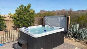 A hot tub in an outdoor setting with a clear view of the surrounding landscape.