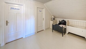 A room with a bed, a nightstand, and a dresser. There are two doors labeled 'Albatross' and 'Eagle'.