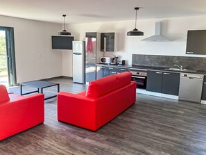 A modern kitchen with grey cabinets, a black range hood, and a stainless steel sink. - Dea Horizon by Interhome (Sainte Lucie Porto Vecchio)