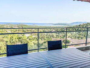 A balcony with a view of a coastal landscape, including hills and a body of water. - Dea Horizon by Interhome (Sainte Lucie Porto Vecchio)