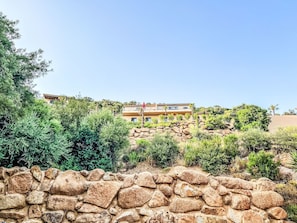 A stone wall with a building in the background. - Dea Horizon by Interhome (Sainte Lucie Porto Vecchio)