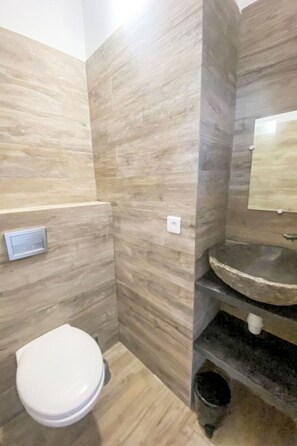 A bathroom with a toilet, a sink, and a mirror. - Dea Sole by Interhome (Sainte Lucie Porto Vecchio)