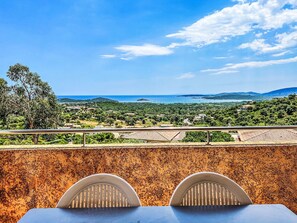 A terrace with a view of a coastal landscape, including a body of water and distant hills. - Dea Alba by Interhome (Sainte Lucie Porto Vecchio)