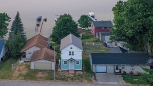 A residential area with houses, a dock, and a boat.