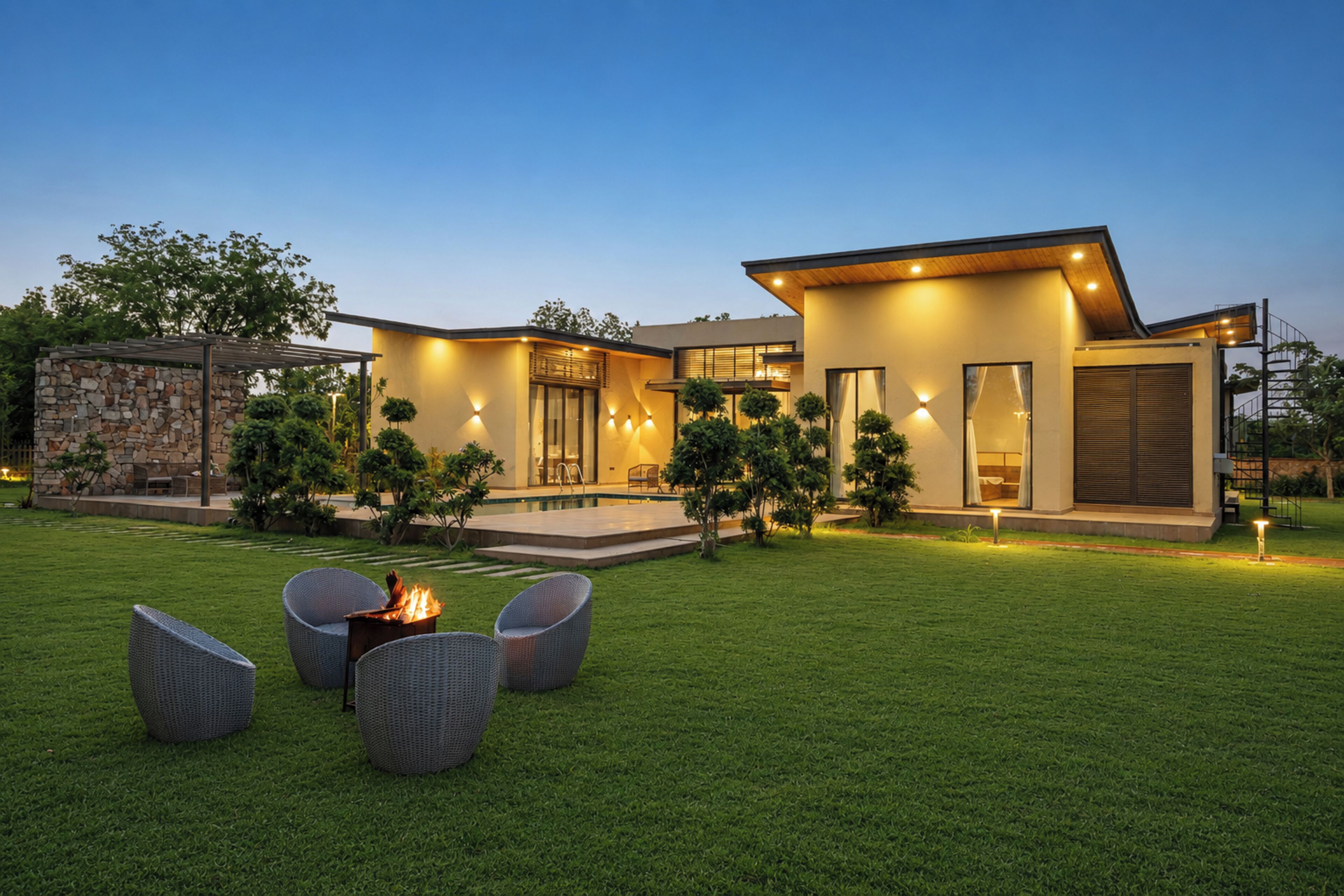 A modern house with a swimming pool, outdoor seating, and a well-maintained lawn.